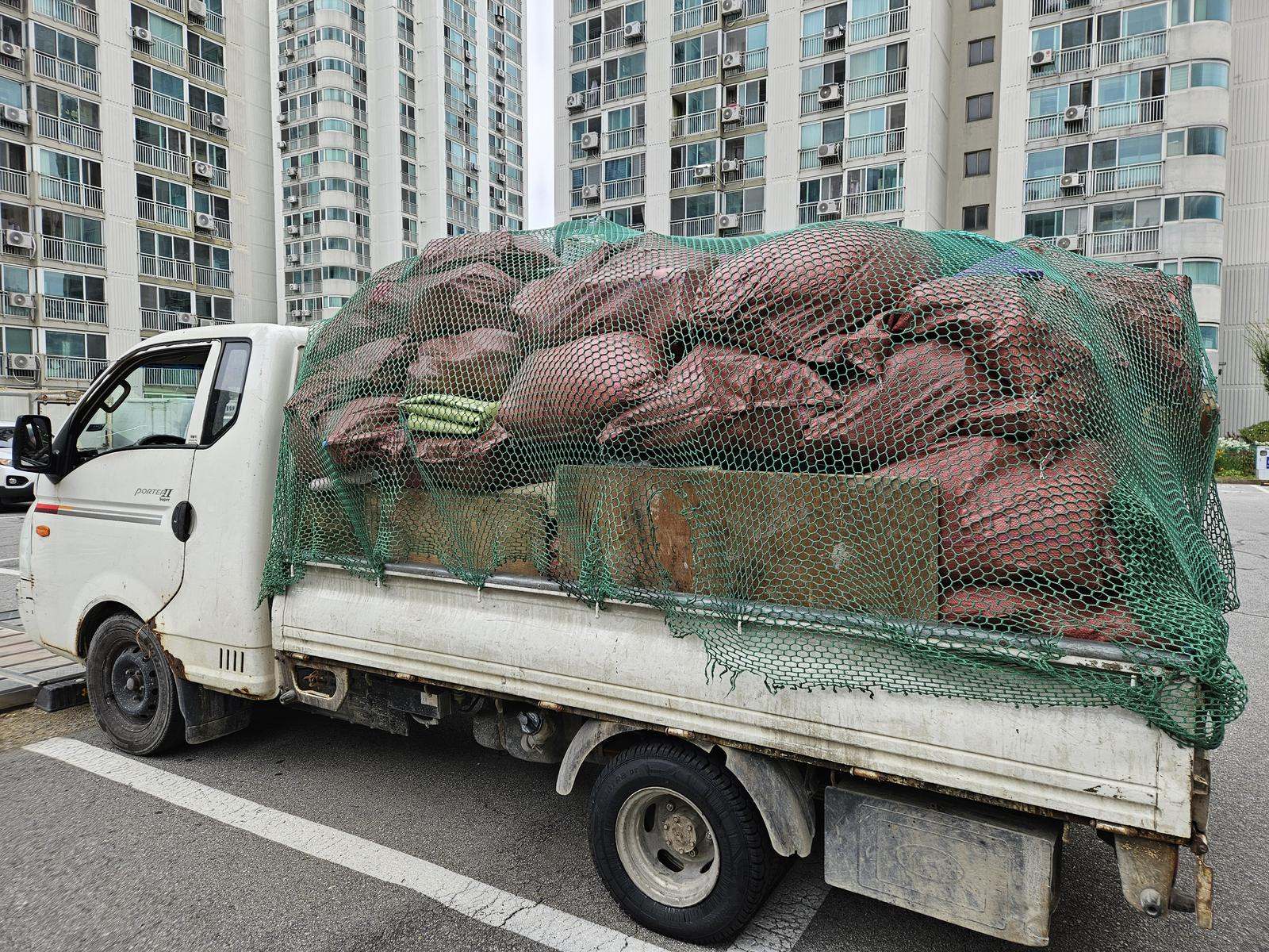 분류한 짐을 마대에 담아 실은 1톤 트럭